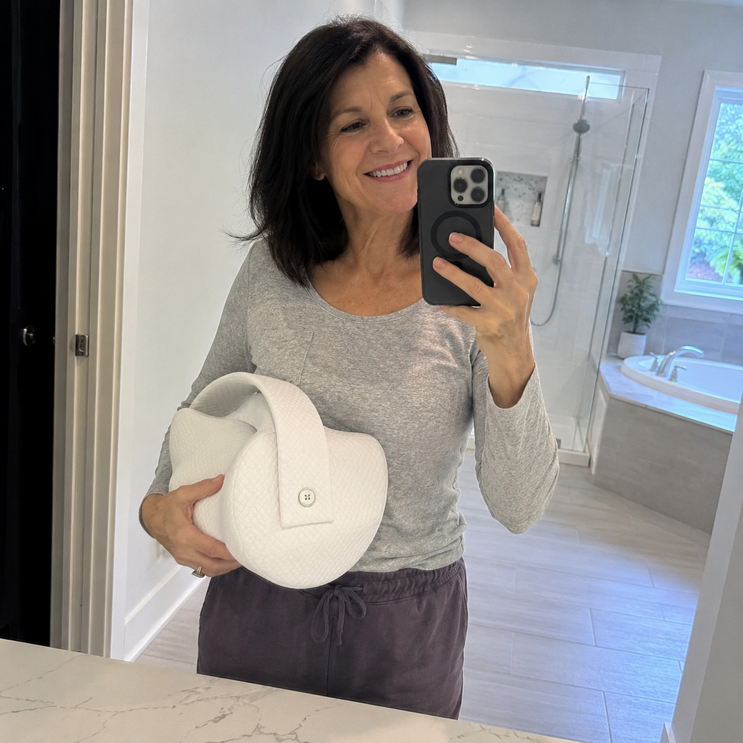 Woman taking a selfie holding the Aline pillow