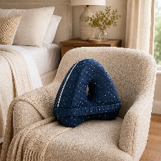 Aline side-sleep pillow resting on a bedroom armchair